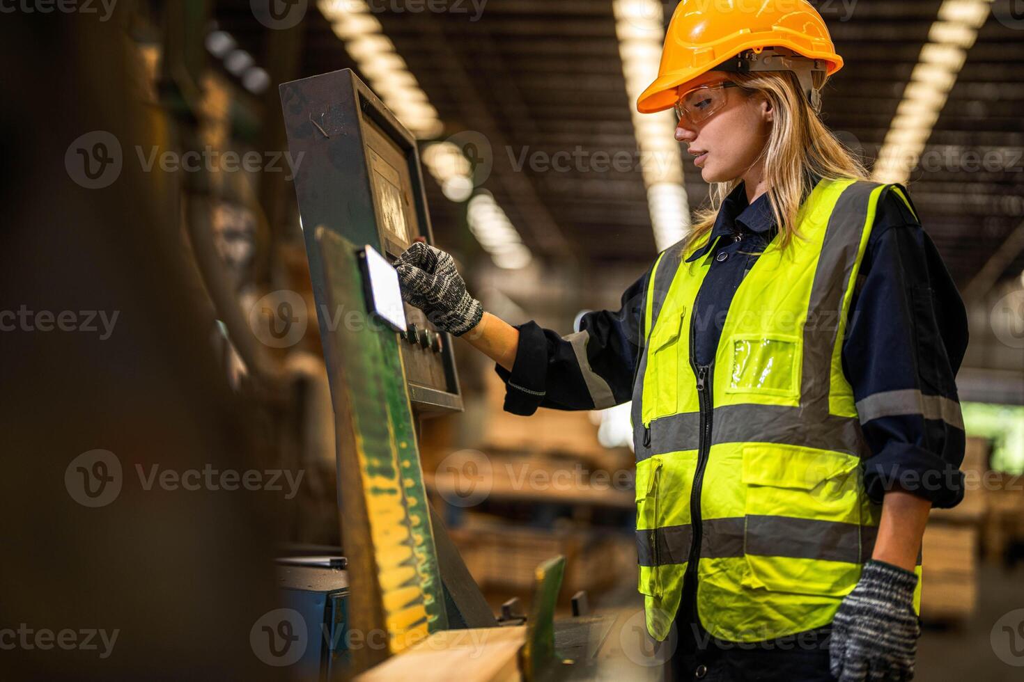 Factory engineer woman standing confident to control panel switch. Worker works at heavy machine at industry factory. worker checking timber of raw wood material. smart industry worker operating. photo