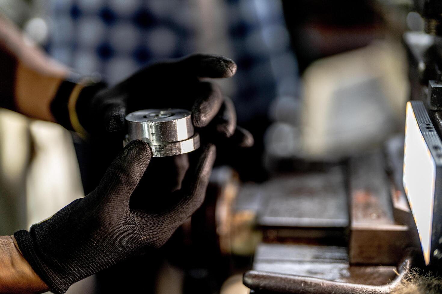 close up hand operation for Metal Lathes. steel column rolling in machine. metalworking industry. worker hand checks mechanic engine. Technician repairing drill bit on metal machine in factory photo