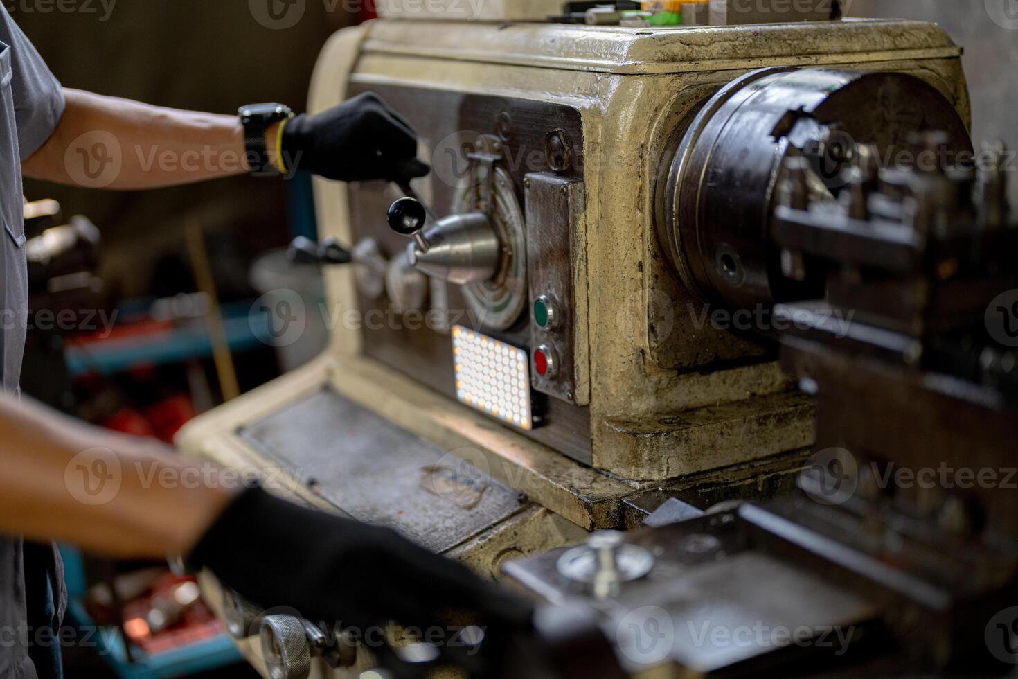 close up hand operation for Metal Lathes. steel column rolling in machine. metalworking industry. worker hand checks mechanic engine. Technician repairing drill bit on metal machine in factory photo