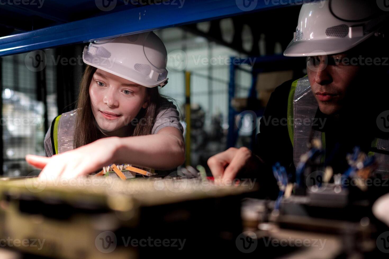 team engineers inspecting on machine with smart tablet. Worker works at heavy machine robot arm. The welding machine with a remote system in an industrial factory. Artificial intelligence concept. photo