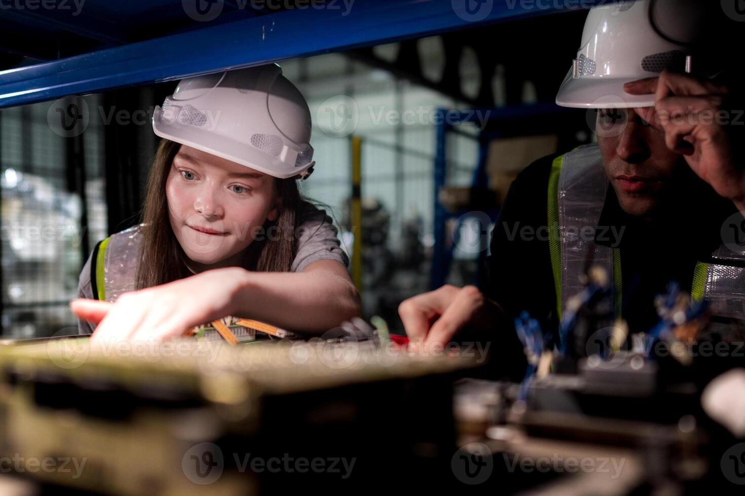 team engineers inspecting on machine with smart tablet. Worker works at heavy machine robot arm. The welding machine with a remote system in an industrial factory. Artificial intelligence concept. photo