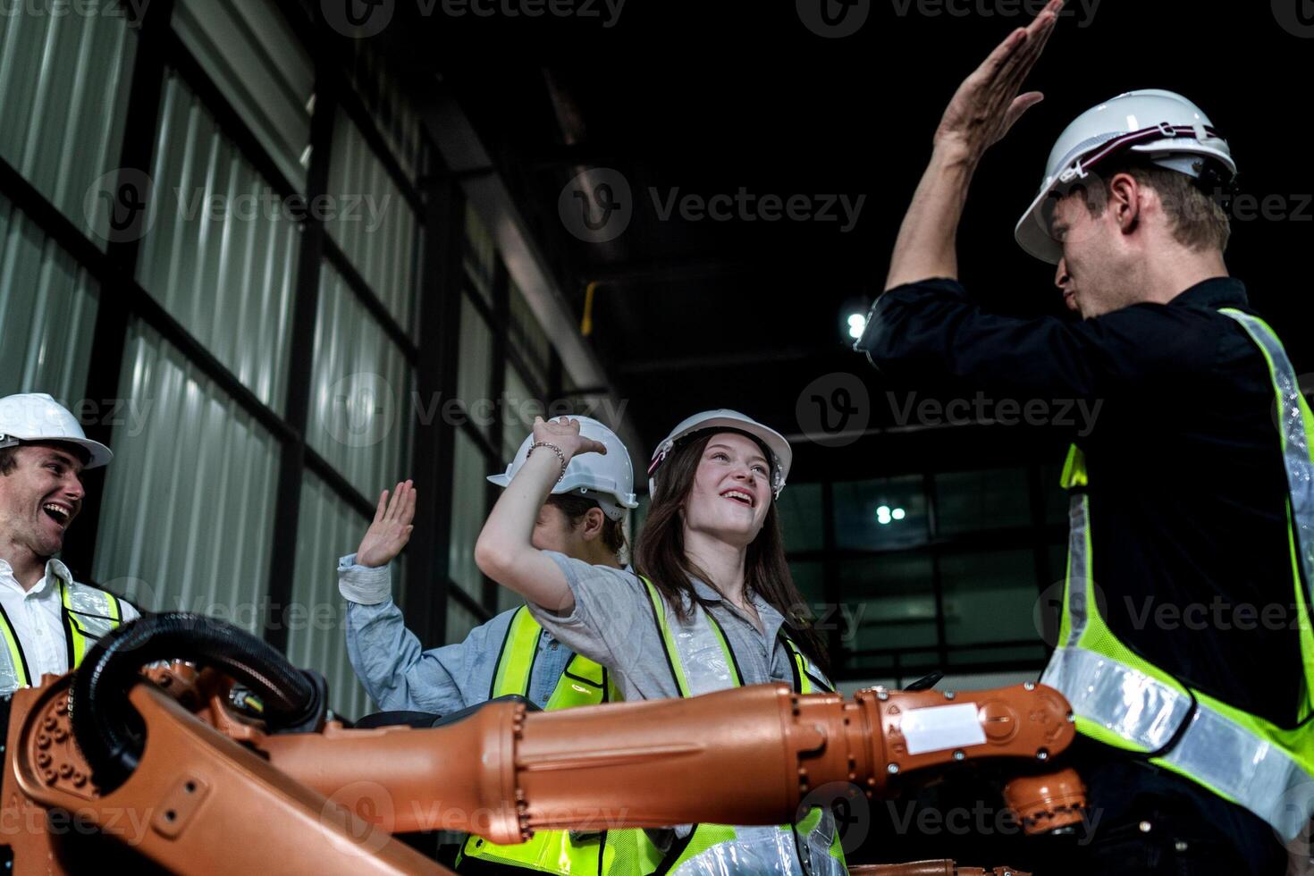 team engineers inspecting on machine with smart tablet. Worker works at heavy machine robot arm. The welding machine with a remote system in an industrial factory. Artificial intelligence concept. photo