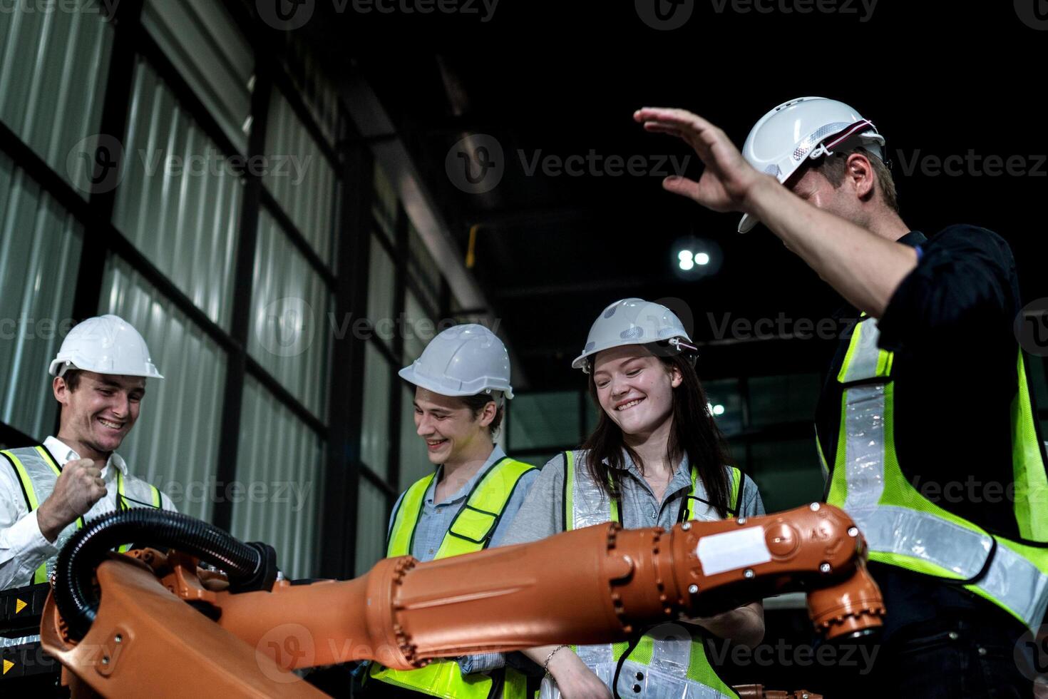 team engineers inspecting on machine with smart tablet. Worker works at heavy machine robot arm. The welding machine with a remote system in an industrial factory. Artificial intelligence concept. photo