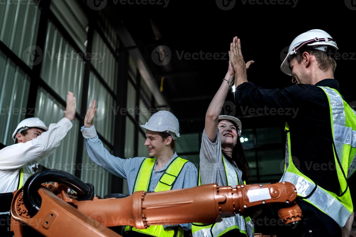 team engineers inspecting on machine with smart tablet. Worker works at heavy machine robot arm. The welding machine with a remote system in an industrial factory. Artificial intelligence concept. photo
