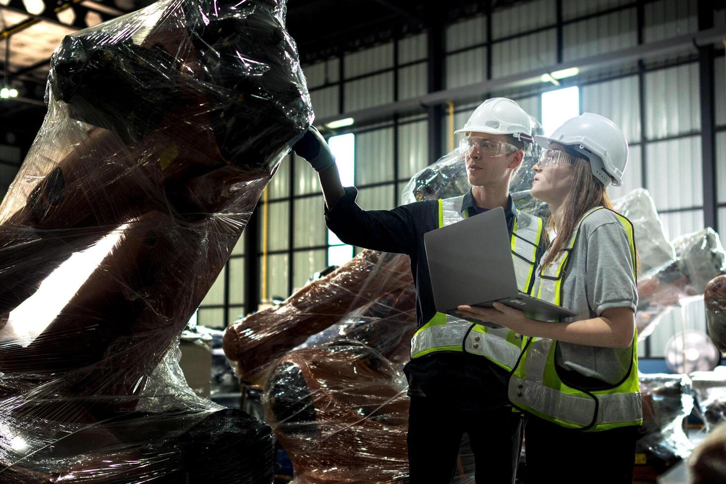 team engineers inspecting on machine with smart tablet. Worker works at heavy machine robot arm. The welding machine with a remote system in an industrial factory. Artificial intelligence concept. photo