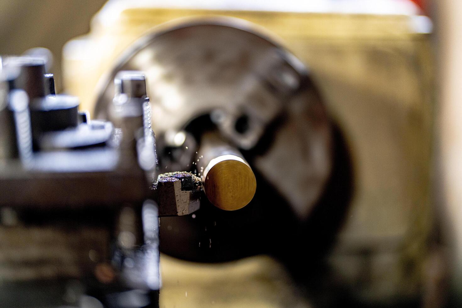 close up of machine operation for Metal Lathes. The steel column rolling in machine. metalworking industry. finishing metal working internal steel surface on lathe grinder machine with flying sparks photo