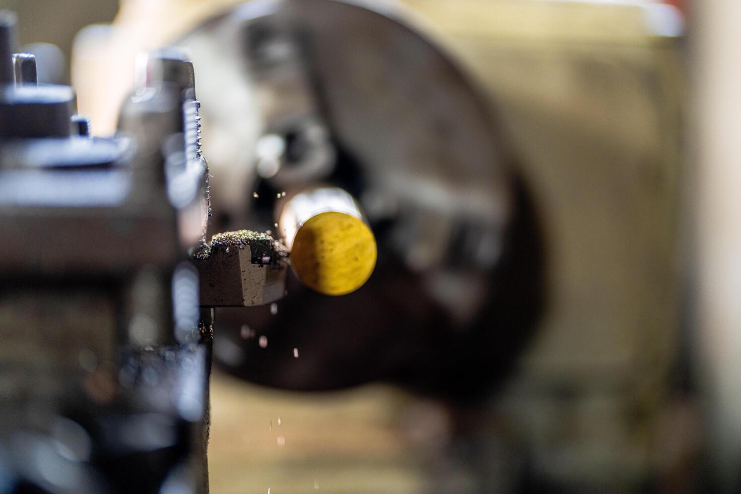 close up of machine operation for Metal Lathes. The steel column rolling in machine. metalworking industry. finishing metal working internal steel surface on lathe grinder machine with flying sparks photo