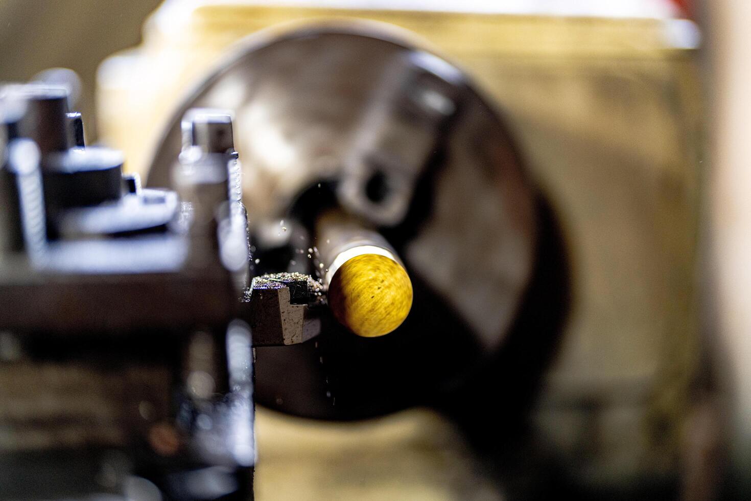 close up of machine operation for Metal Lathes. The steel column rolling in machine. metalworking industry. finishing metal working internal steel surface on lathe grinder machine with flying sparks photo