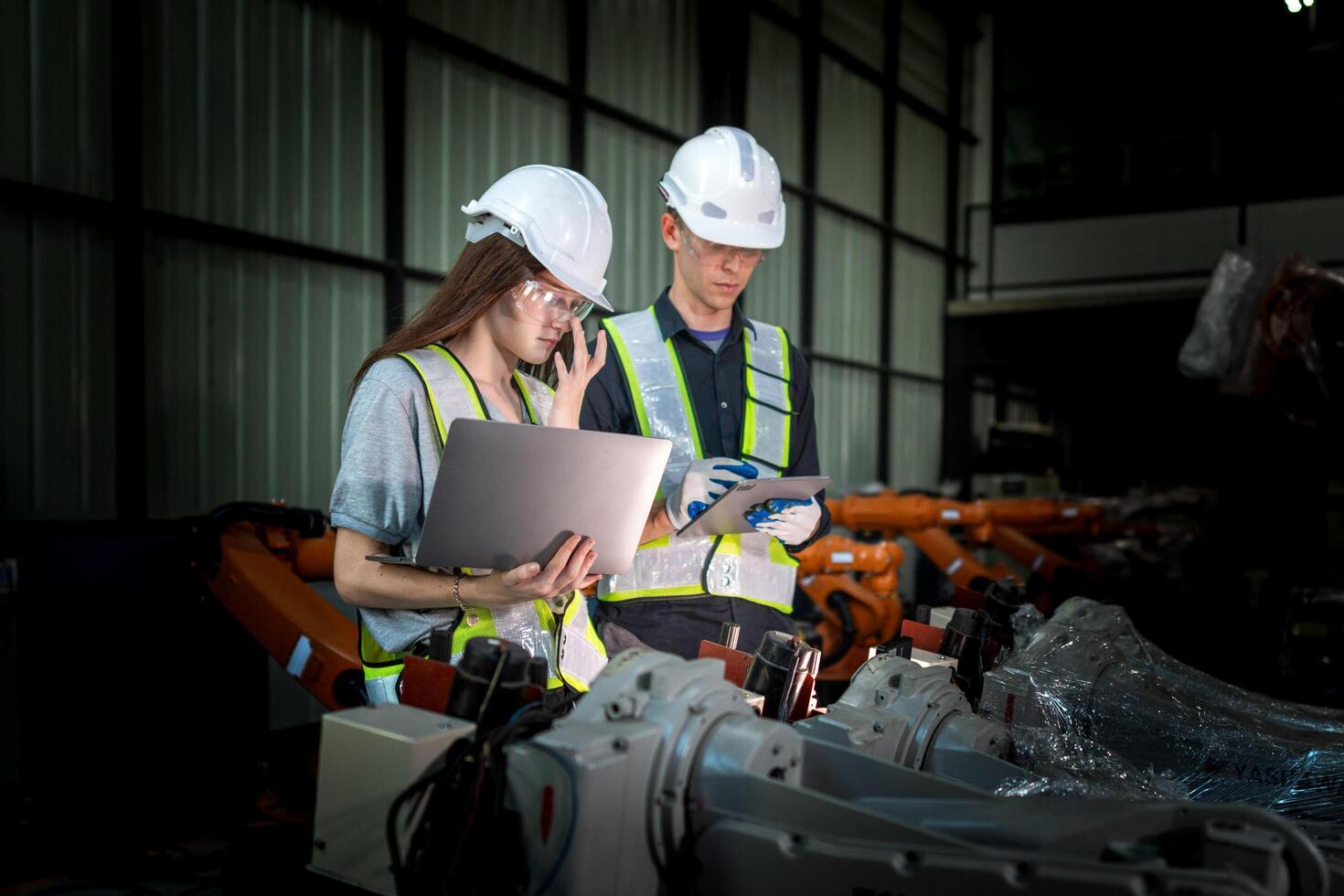 Sales manager and factory owner in suits negotiating selling robots used in the factory. Business engineers meeting and checking new machine robot. Workers walking at warehouse welding machine. photo