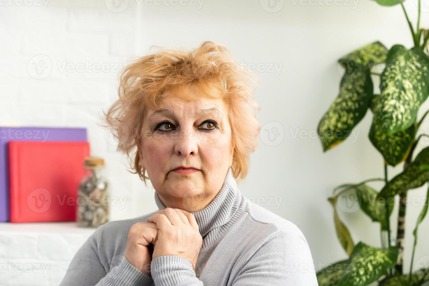 Head shot mature woman looking at camera and talking, grandmother chatting with relative online, making call, middle aged blogger recording vlog, teacher speaking to webcam, distance lecture photo