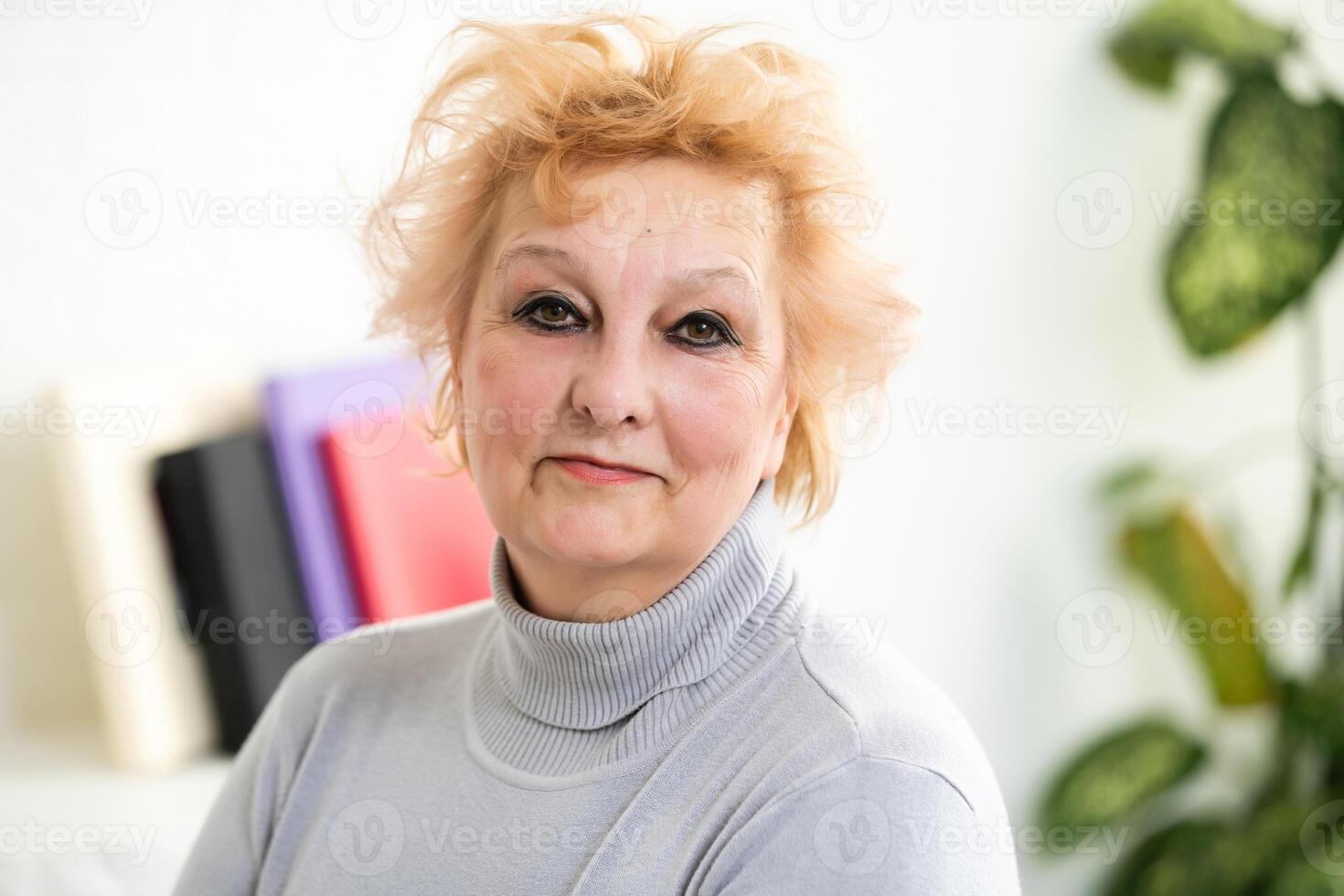 Head shot mature woman looking at camera and talking, grandmother chatting with relative online, making call, middle aged blogger recording vlog, teacher speaking to webcam, distance lecture photo