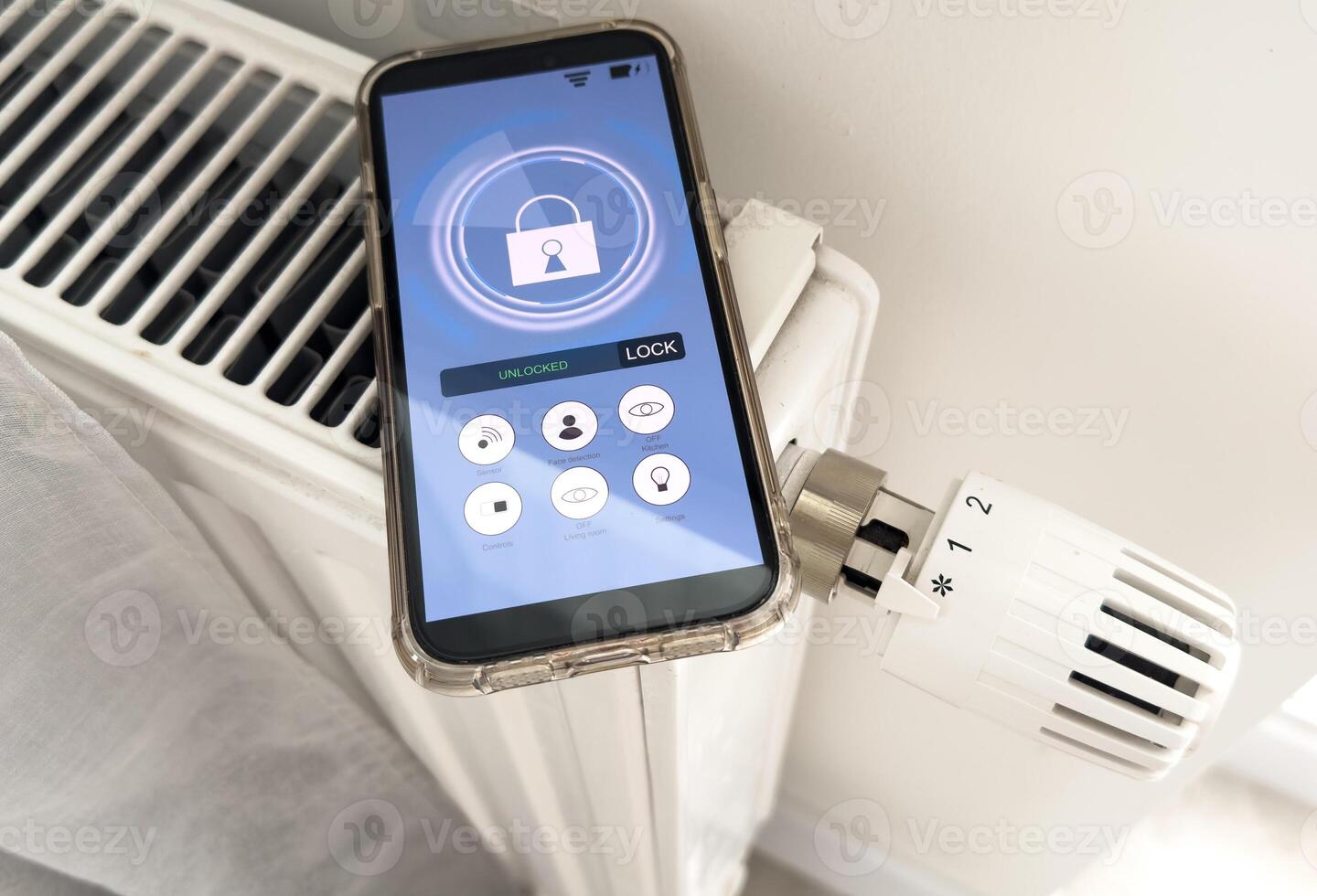 Adjusting Temperature Of Digital Smart Thermostat Using Mobile Phone App At Home photo