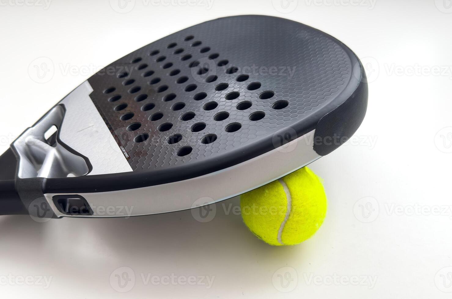 blue professional paddle tennis racket with yellow ball on white background. copy space for text photo