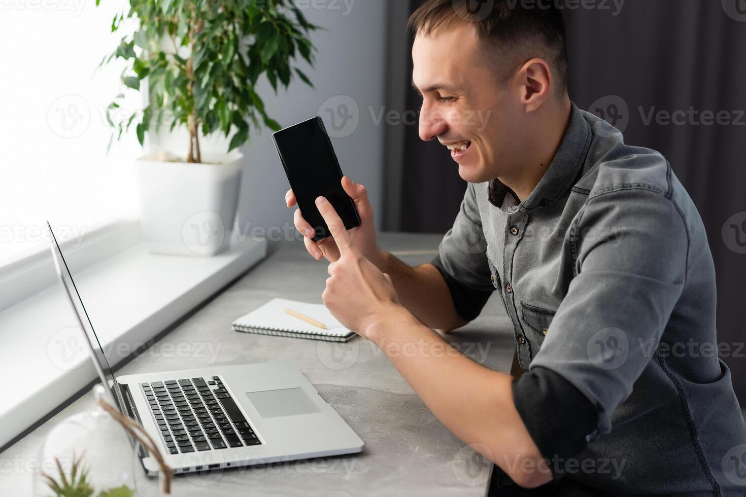 Excited worker sitting at desk in coworking space use computer reading message looking at device screen received great unbelievable opportunity or reward. Motivated employee celebrating job promotion photo