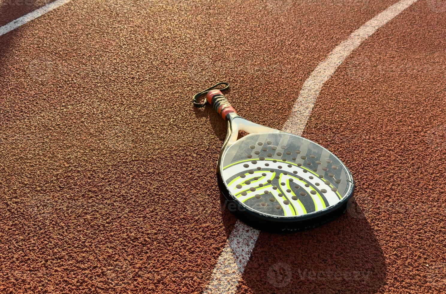 professional paddle tennis racket with natural lighting on court background. Horizontal sport theme poster, greeting cards, headers, website and app photo
