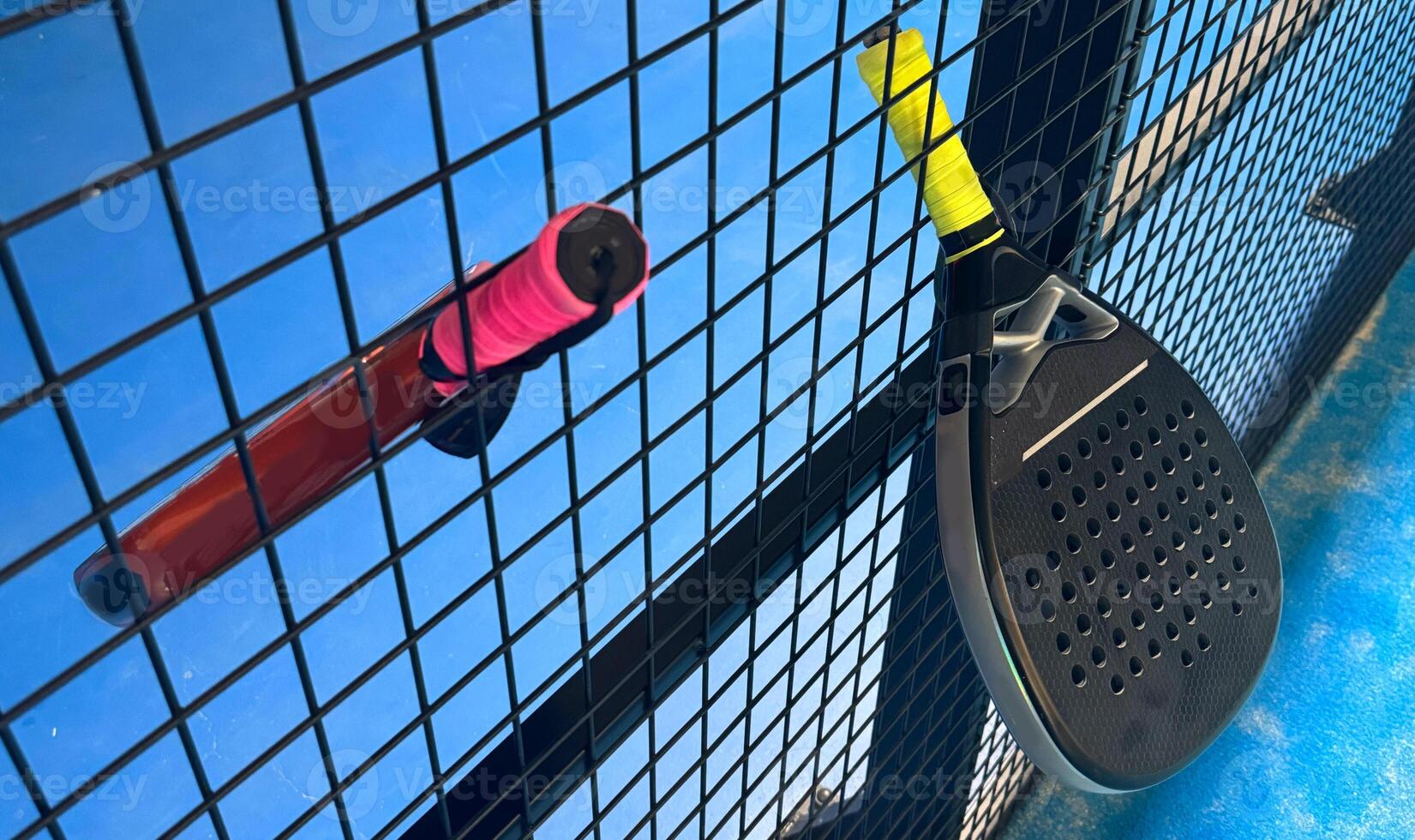 a paddle racket and ball on a court photo