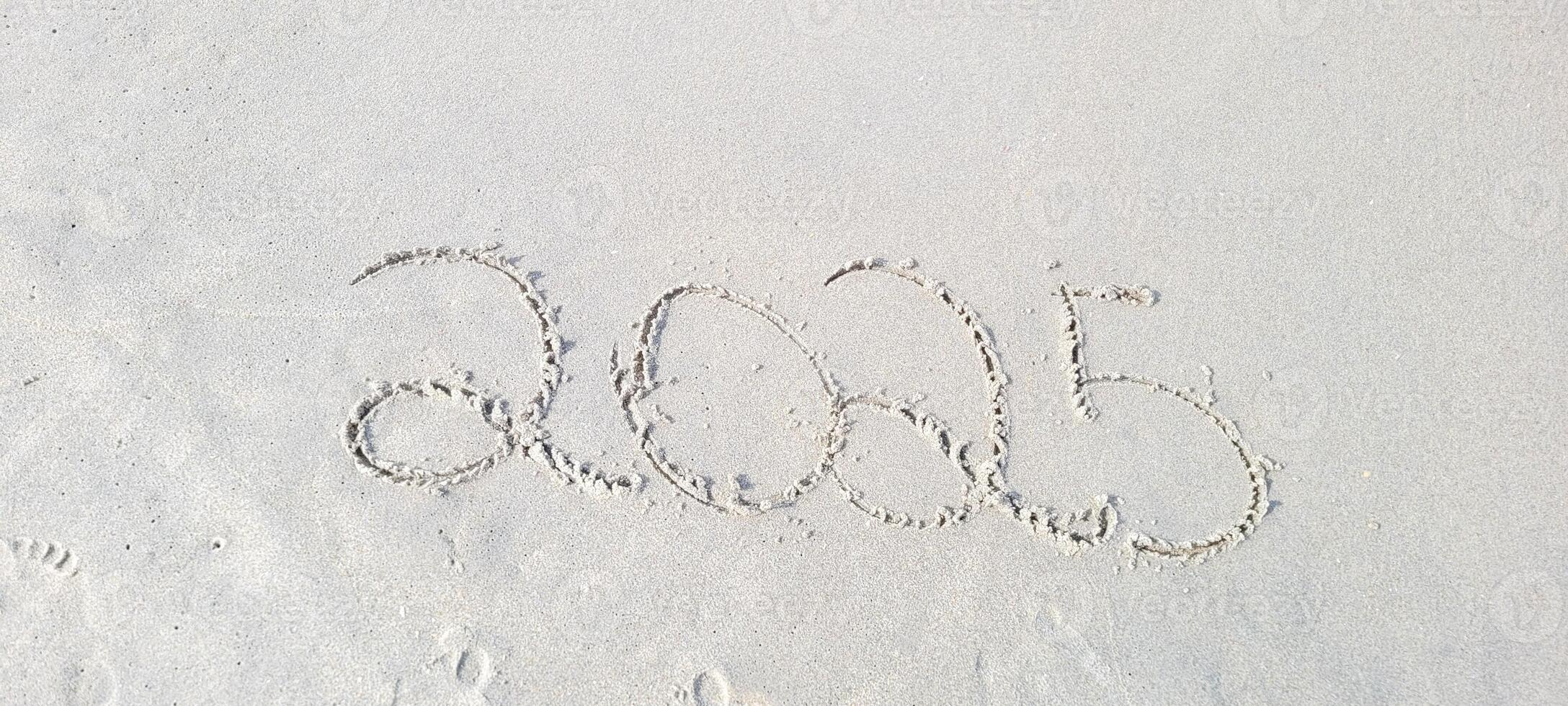 happy 2025 written in the sand of itamambuca ubatuba beach photo
