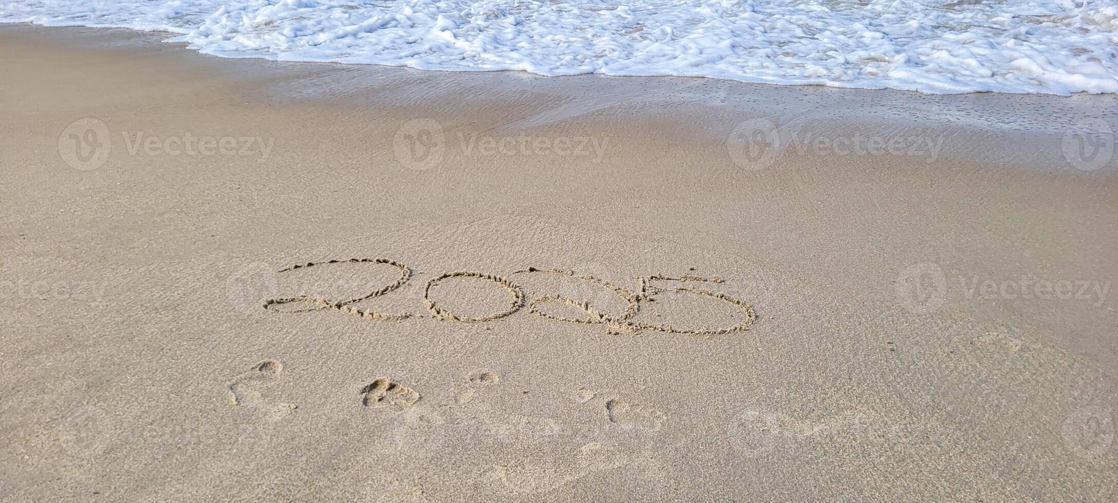 happy 2025 written in the sand of itamambuca ubatuba beach photo