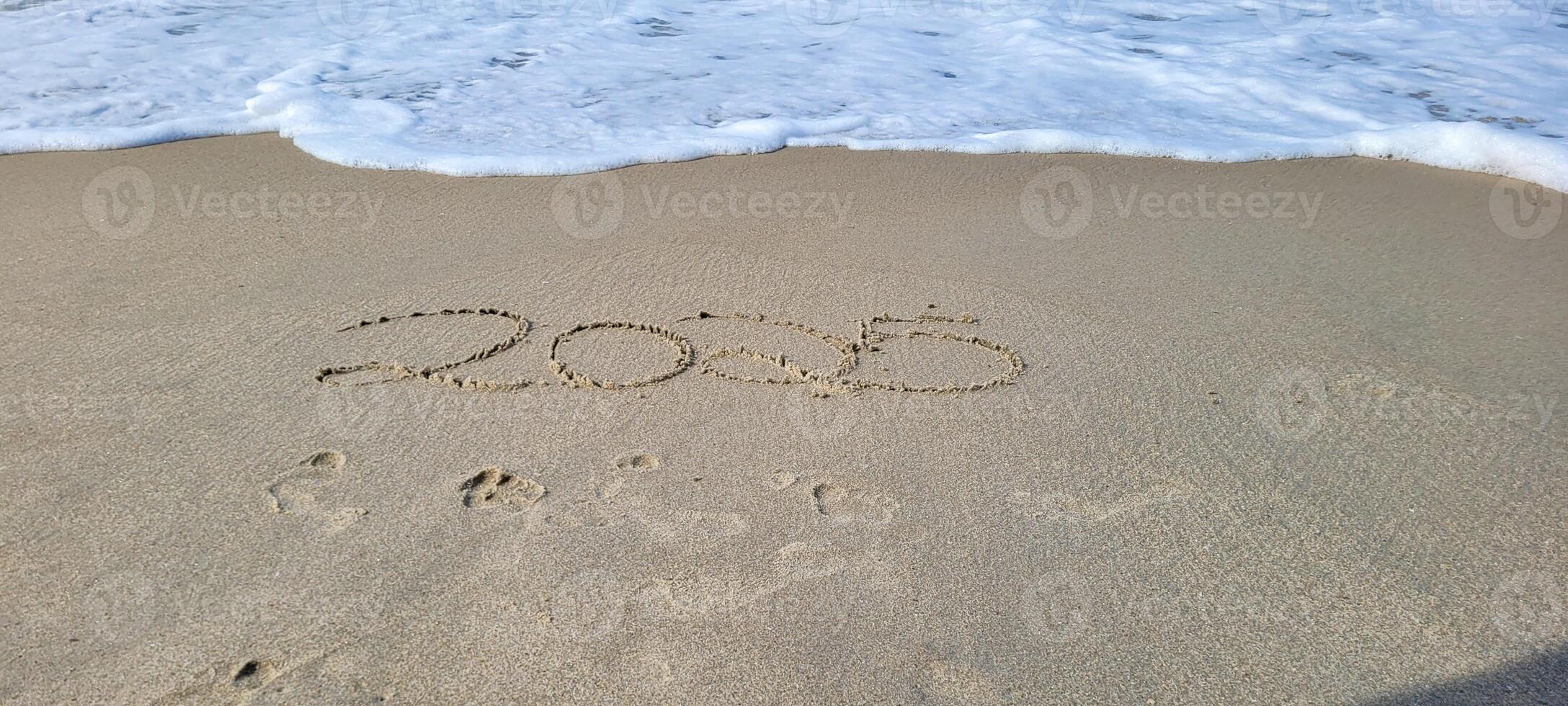 happy 2025 written in the sand of itamambuca ubatuba beach photo