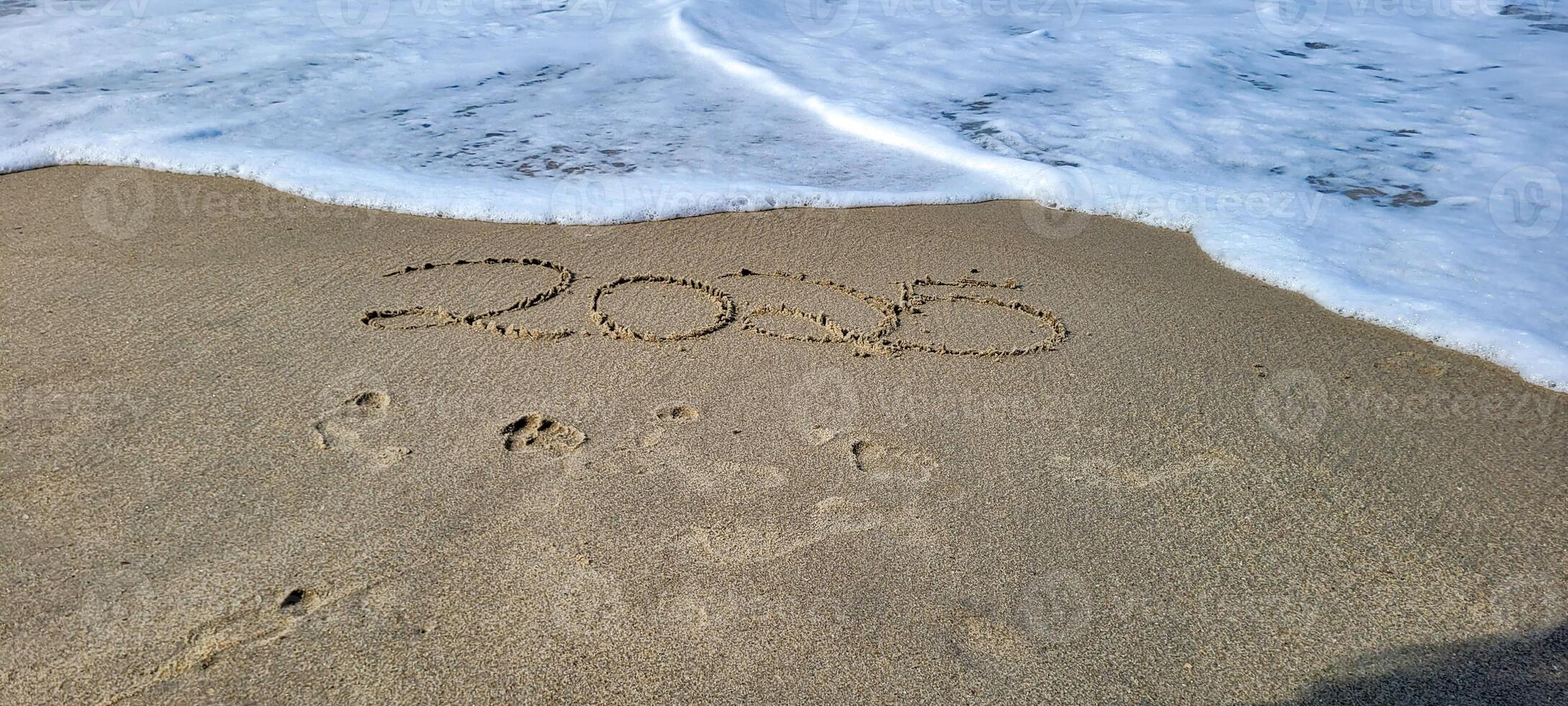 happy 2025 written in the sand of itamambuca ubatuba beach photo
