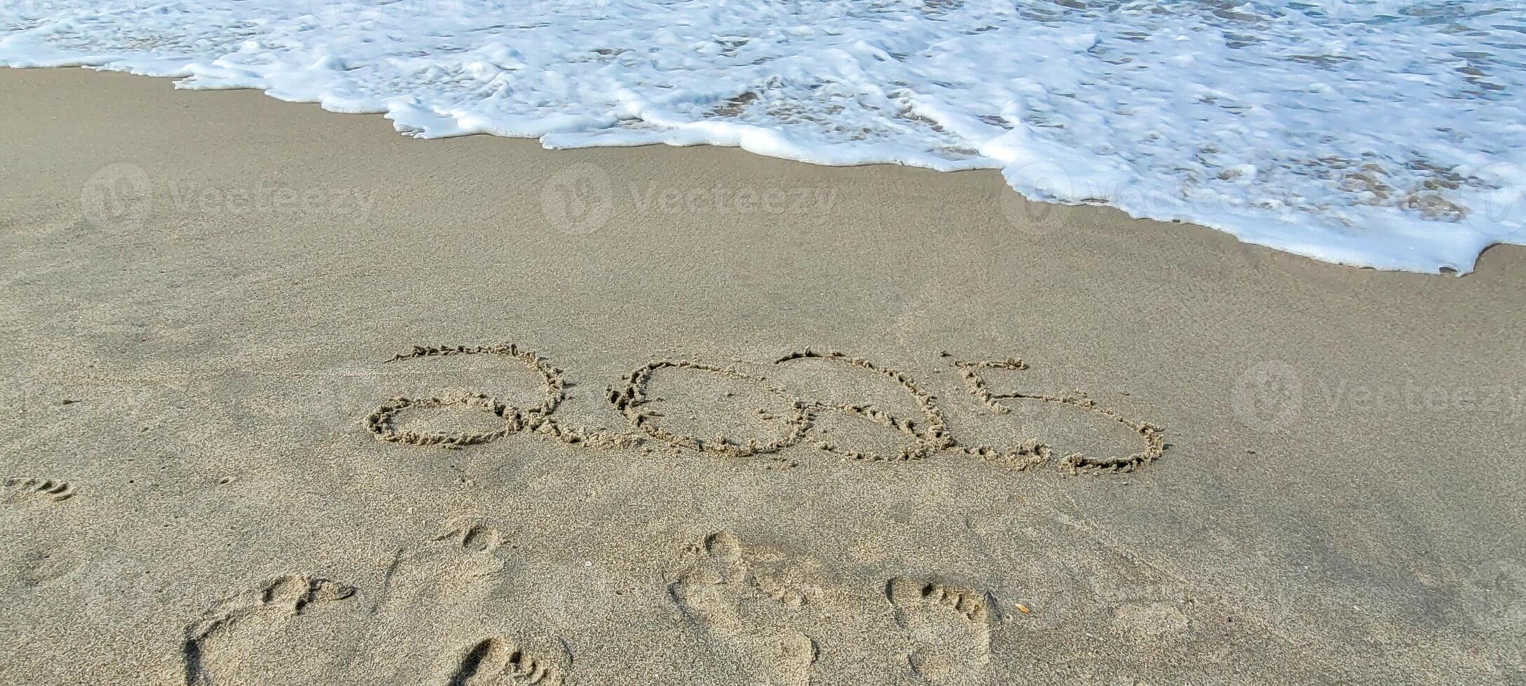 happy 2025 written in the sand of itamambuca ubatuba beach photo