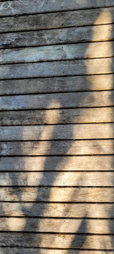 old slatted wood background with shadows photo