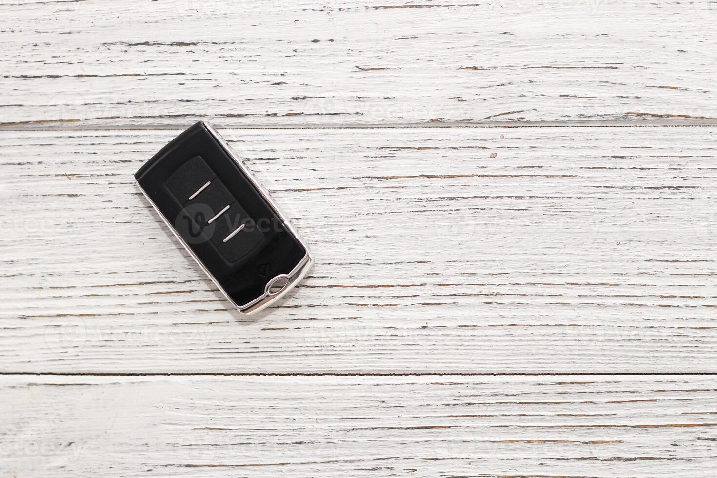 car keys, remote control on a wooden background photo