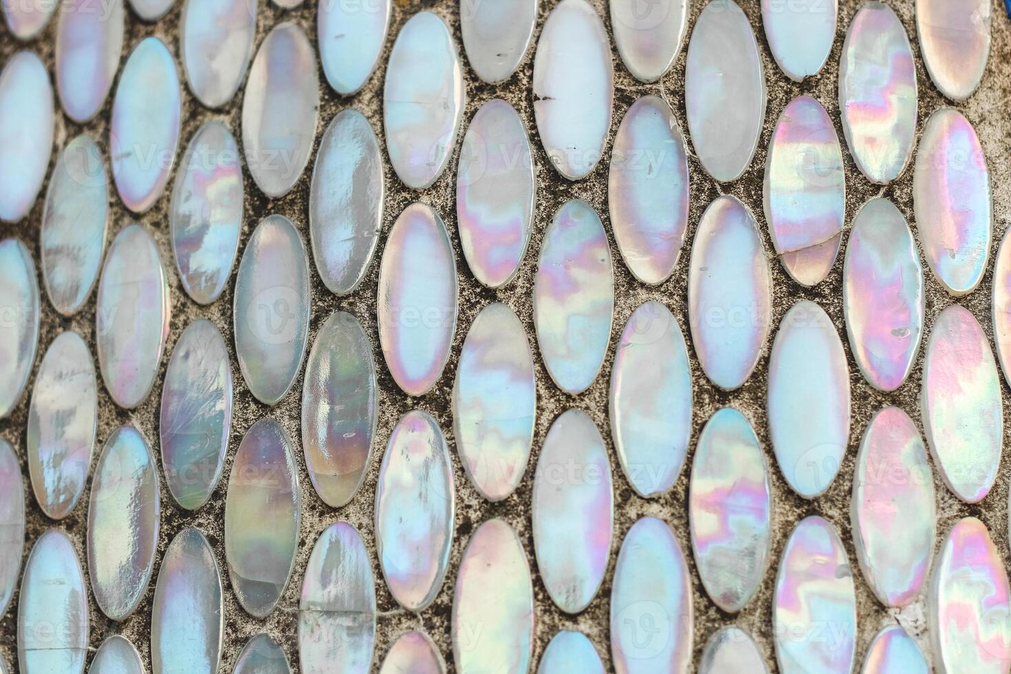 Texture of mother-of-pearl mosaic round tiles, close-up photo