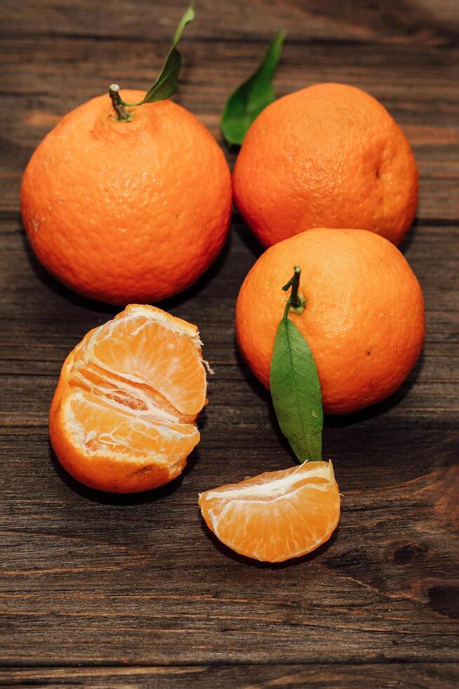 Tangerines on the background of a wooden brown table with boards photo