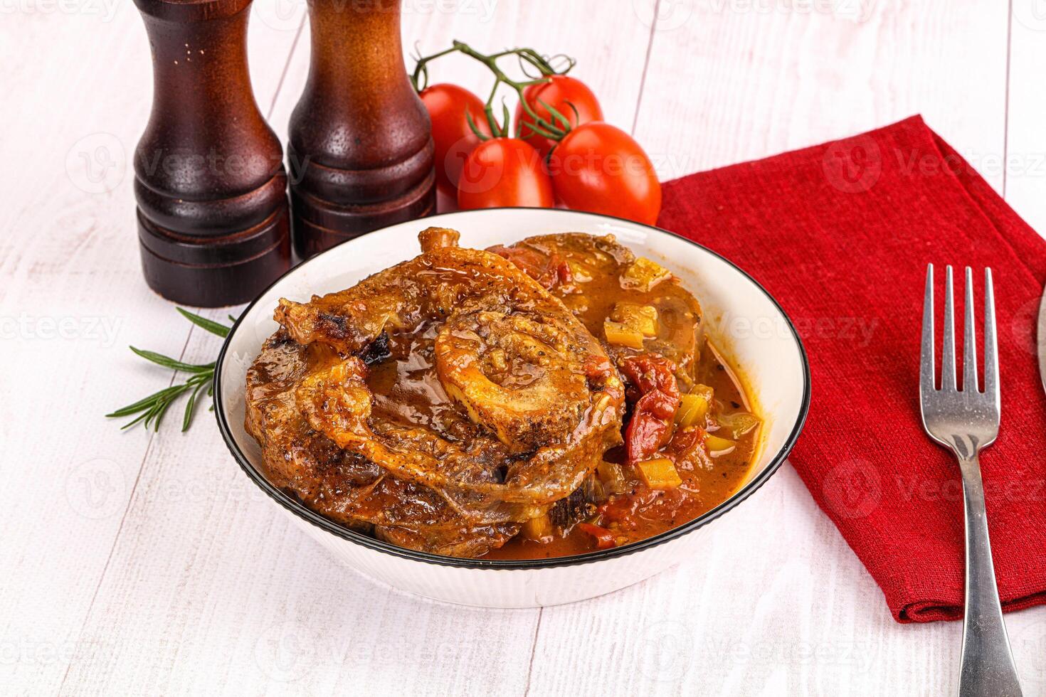 Italian cuisine - ossobuco with sauce photo