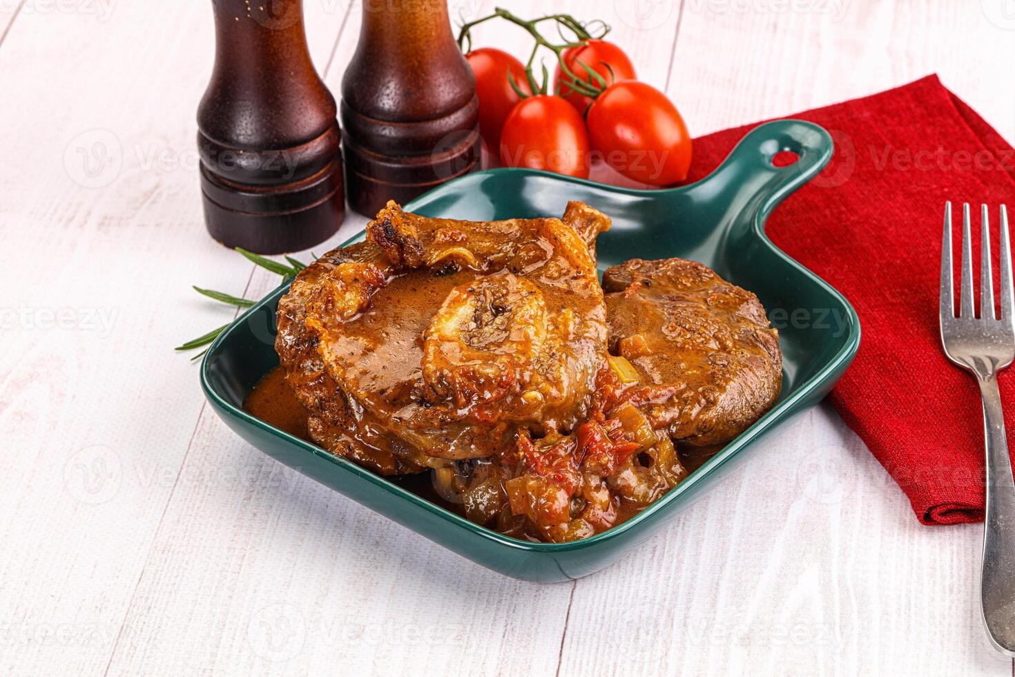 Italian cuisine - ossobuco with sauce photo