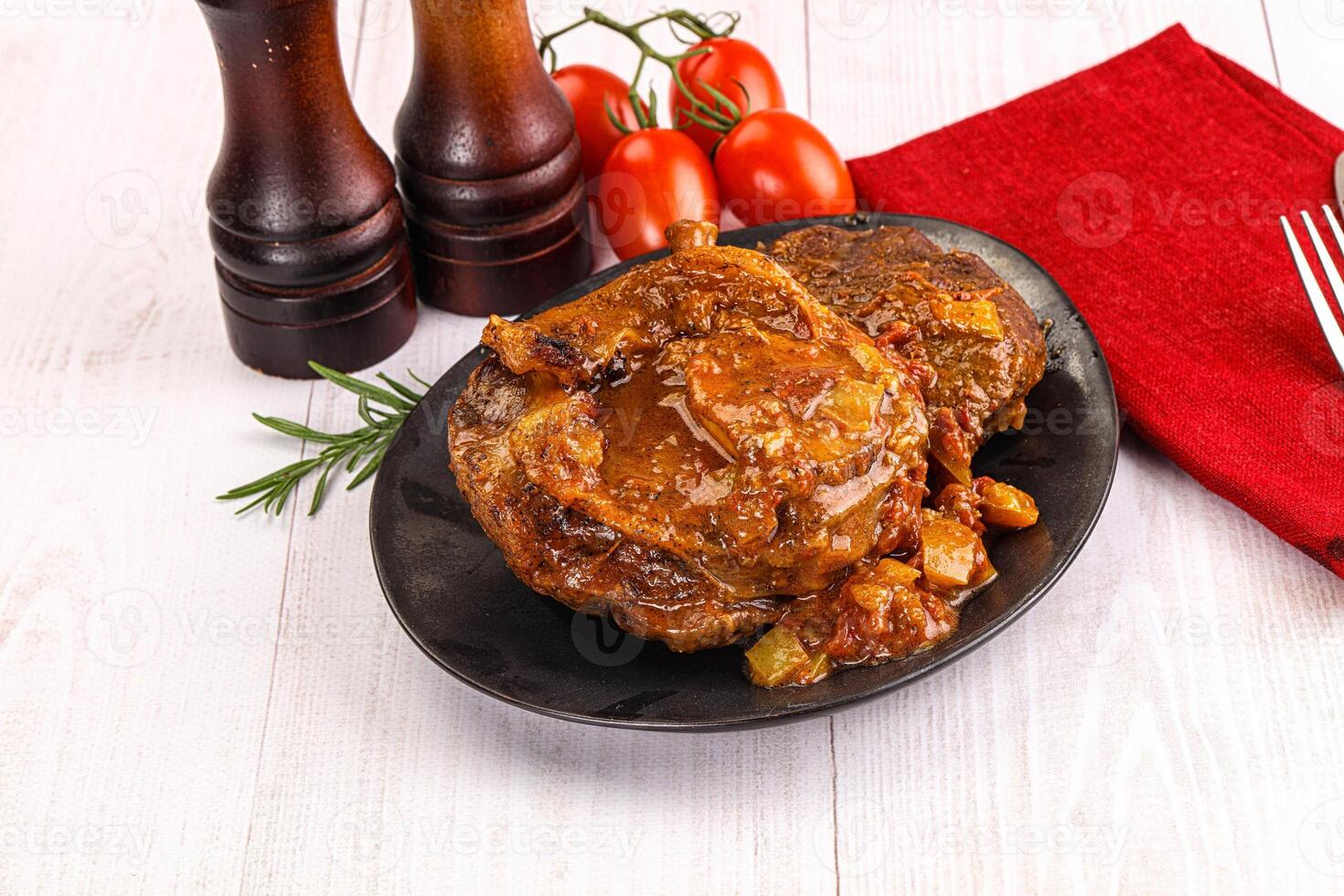 Italian cuisine - ossobuco with sauce photo