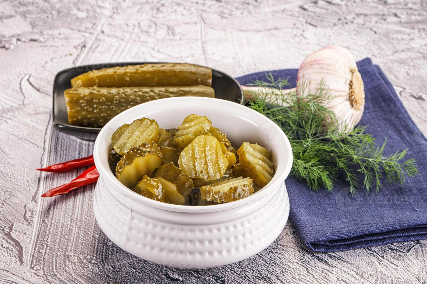 Sliced marinated cucumbers in the bowl photo