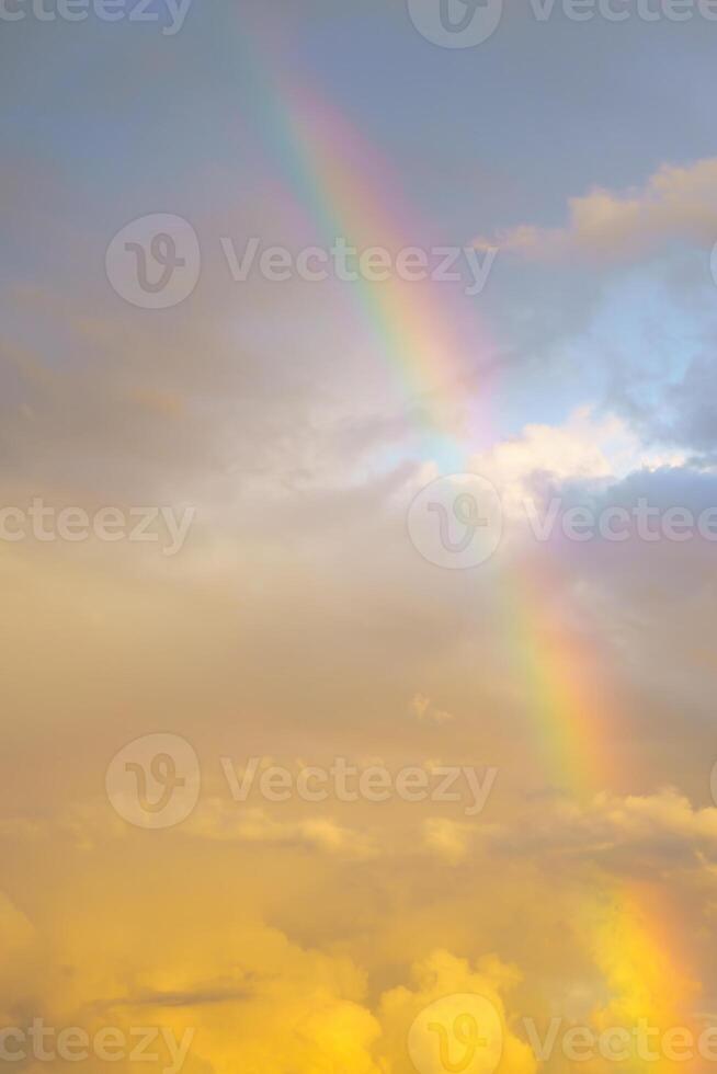 Rainbow against cloudy sunset sky. Nature background. Weather after rain. photo