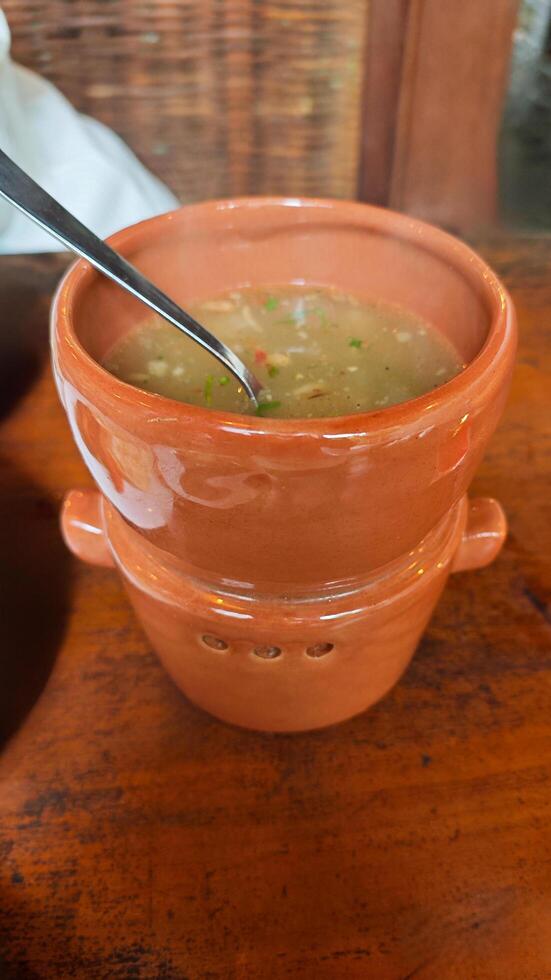 Ceramic Terracotta Kitchenware for Keeping Food Warm with Soup in Rustic Restaurant Setting photo