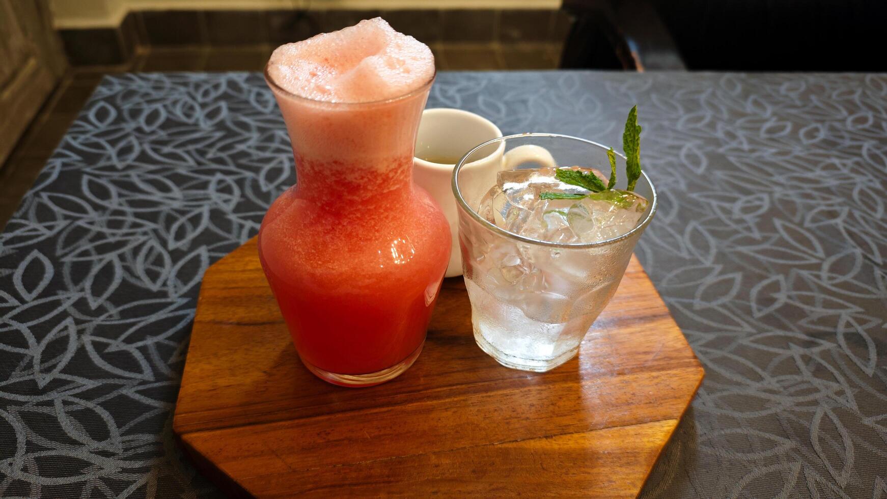 Refreshing Watermelon Juice with Sugar Syrup and Ice on Wooden Tray in Cozy Cafe photo