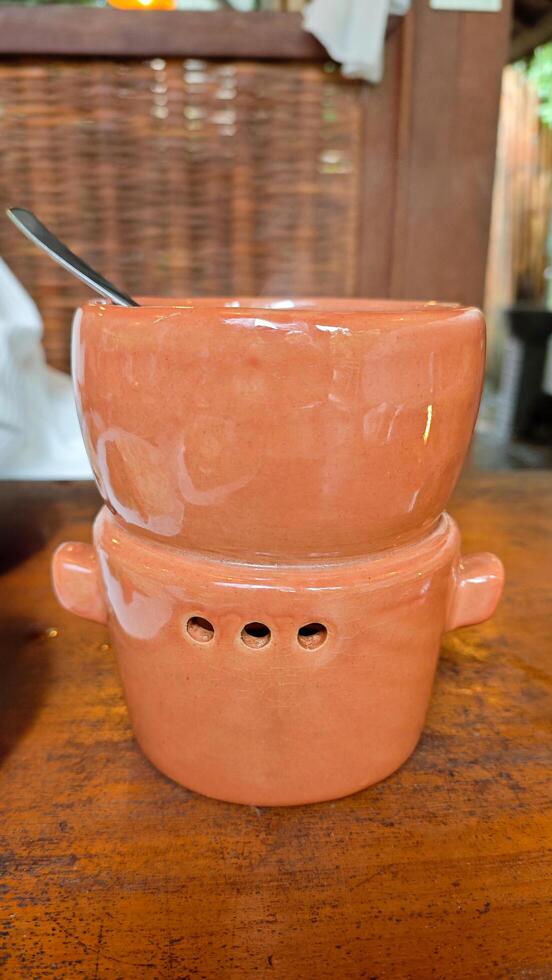 Ceramic Terracotta Kitchenware for Keeping Food Warm with Soup in Rustic Restaurant Setting photo