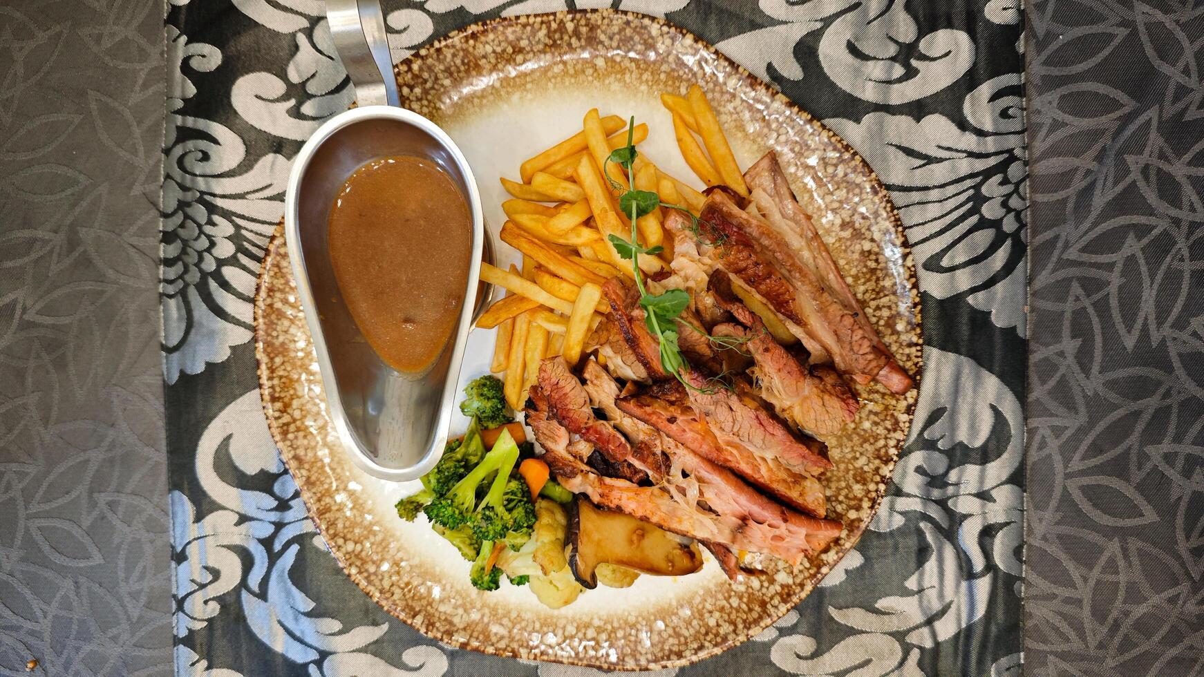 Smoked Brisket with Barbecue Sauce and Vegetables on a Decorative Plate photo