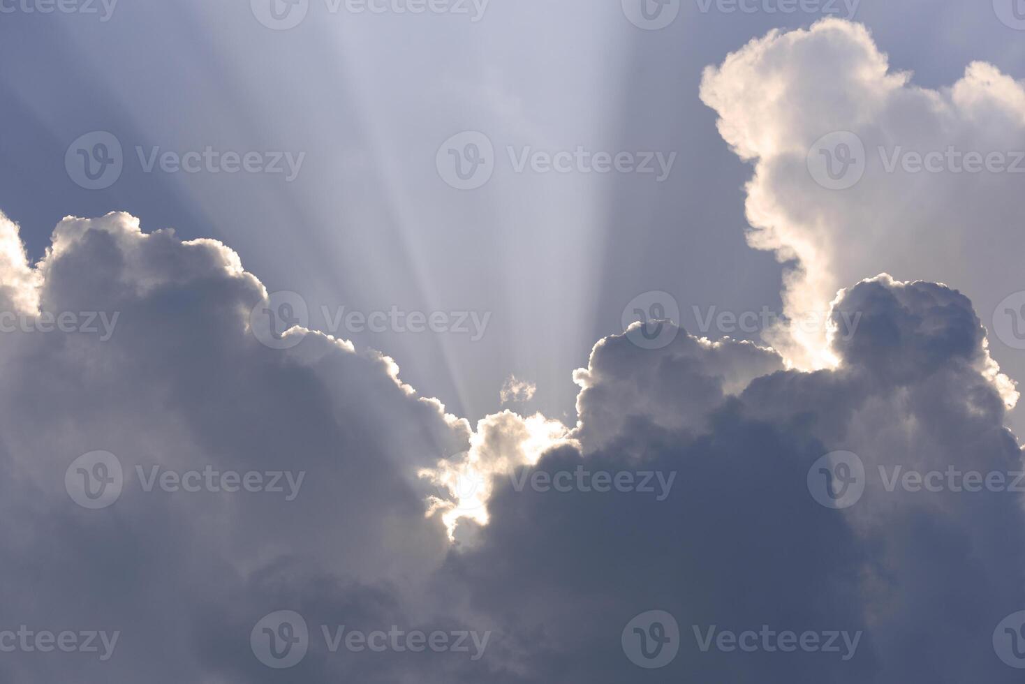 Blue-white cumulus clouds in the rays of the sun. Thunderstorm clouds. photo