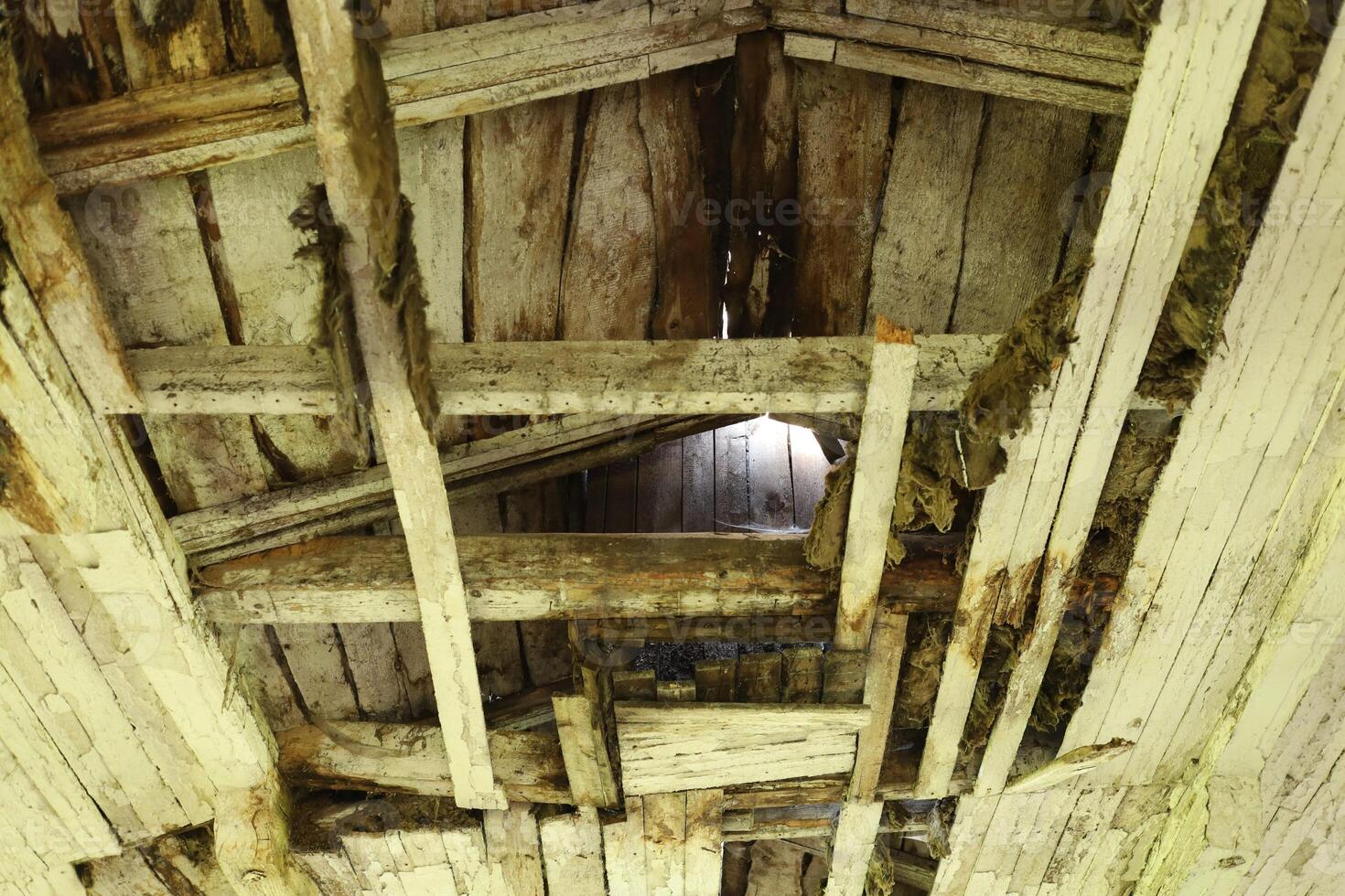 Old and ruined wooden ceiling in the room. photo