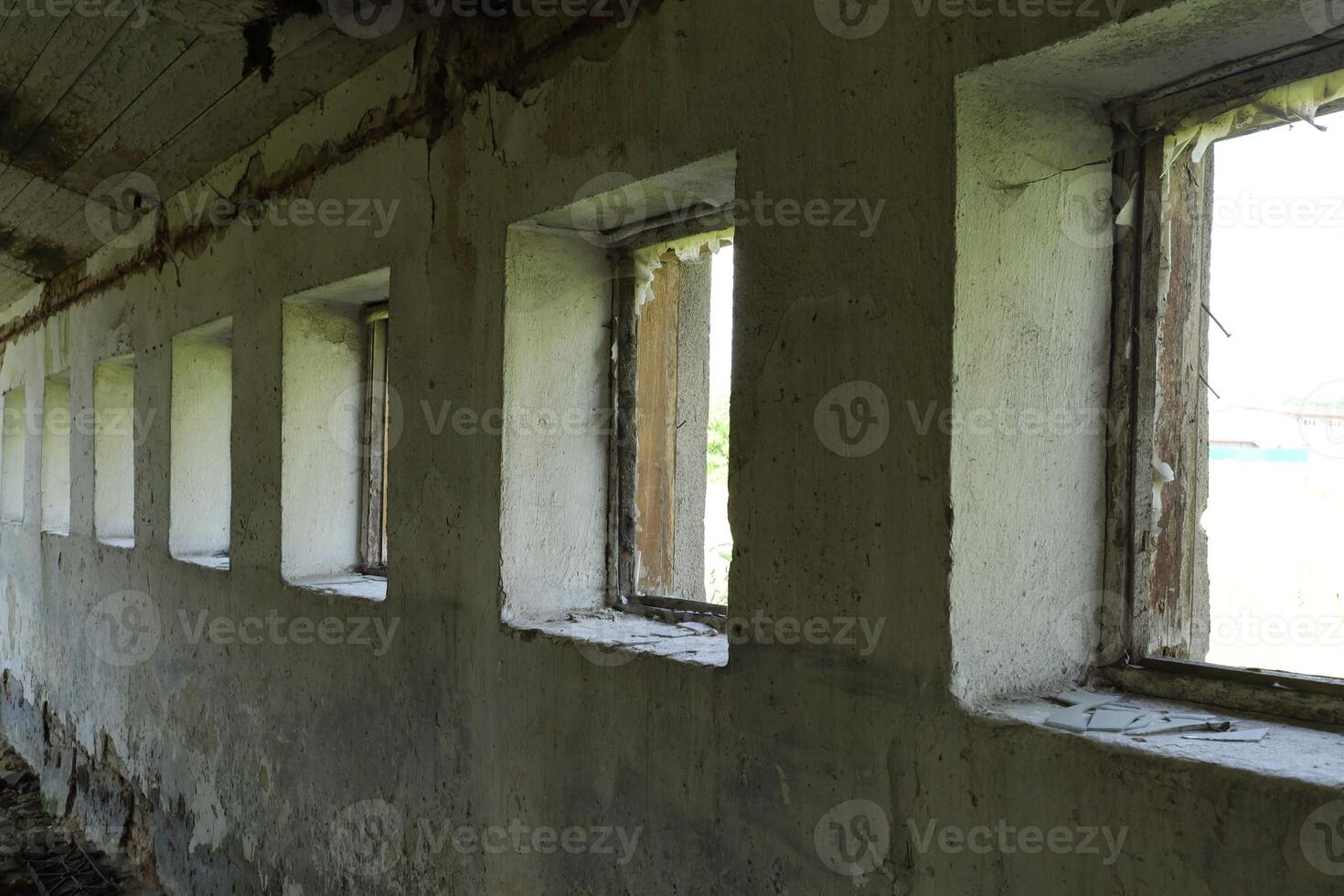 Old wall with windows in an abandoned room. photo