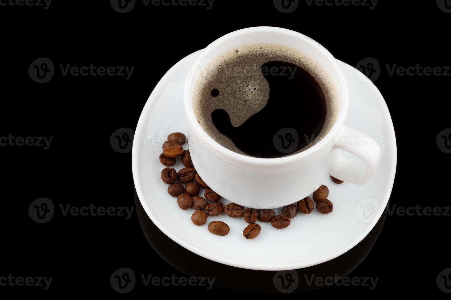 Coffee drink in a white cup and grains on a black background photo