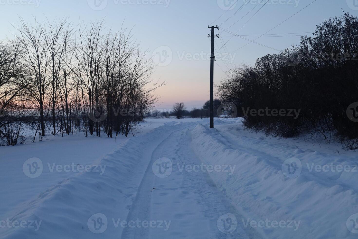 A deserted winter road in a village with snow photo