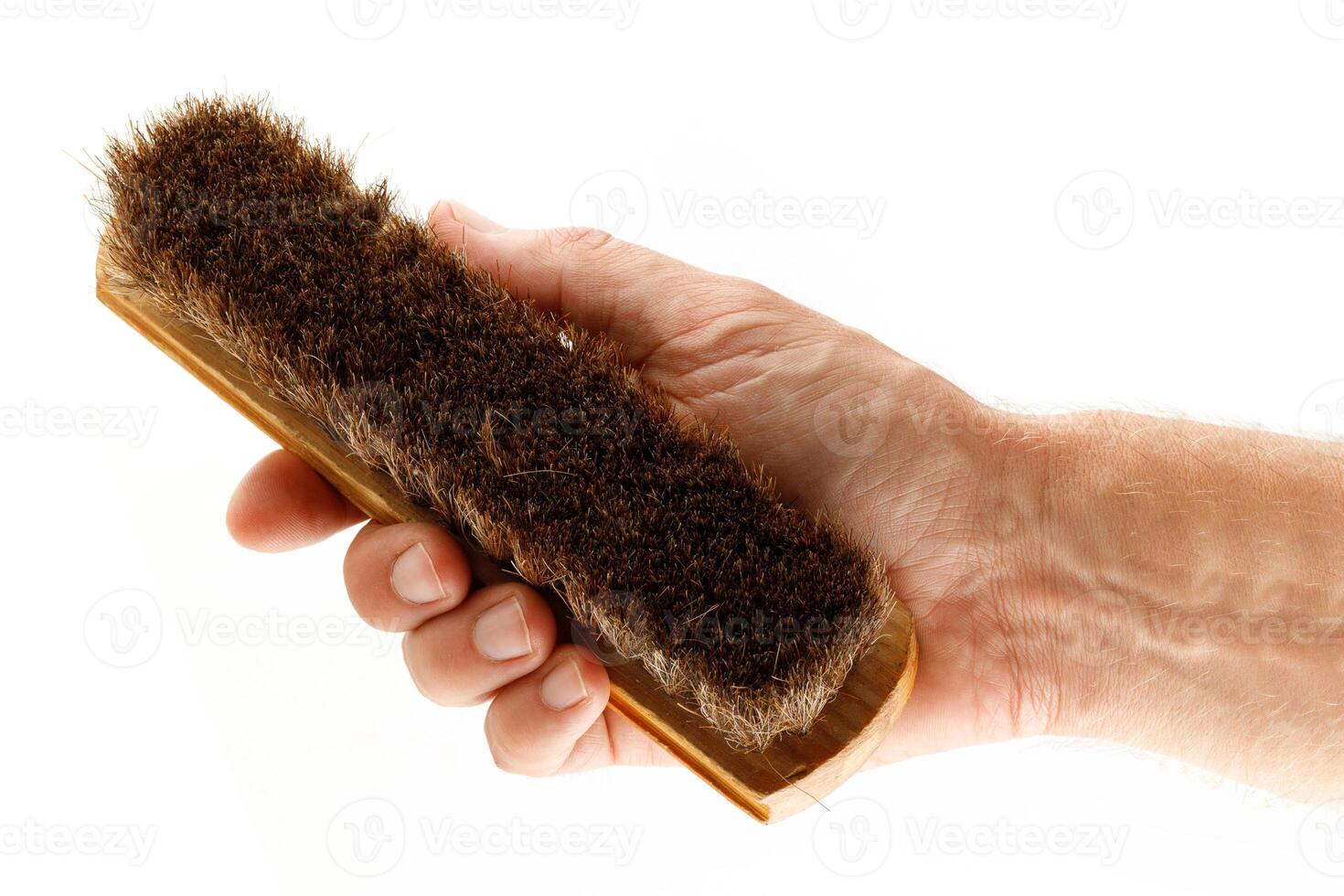 Hand holds a brush to clean clothes isolate photo
