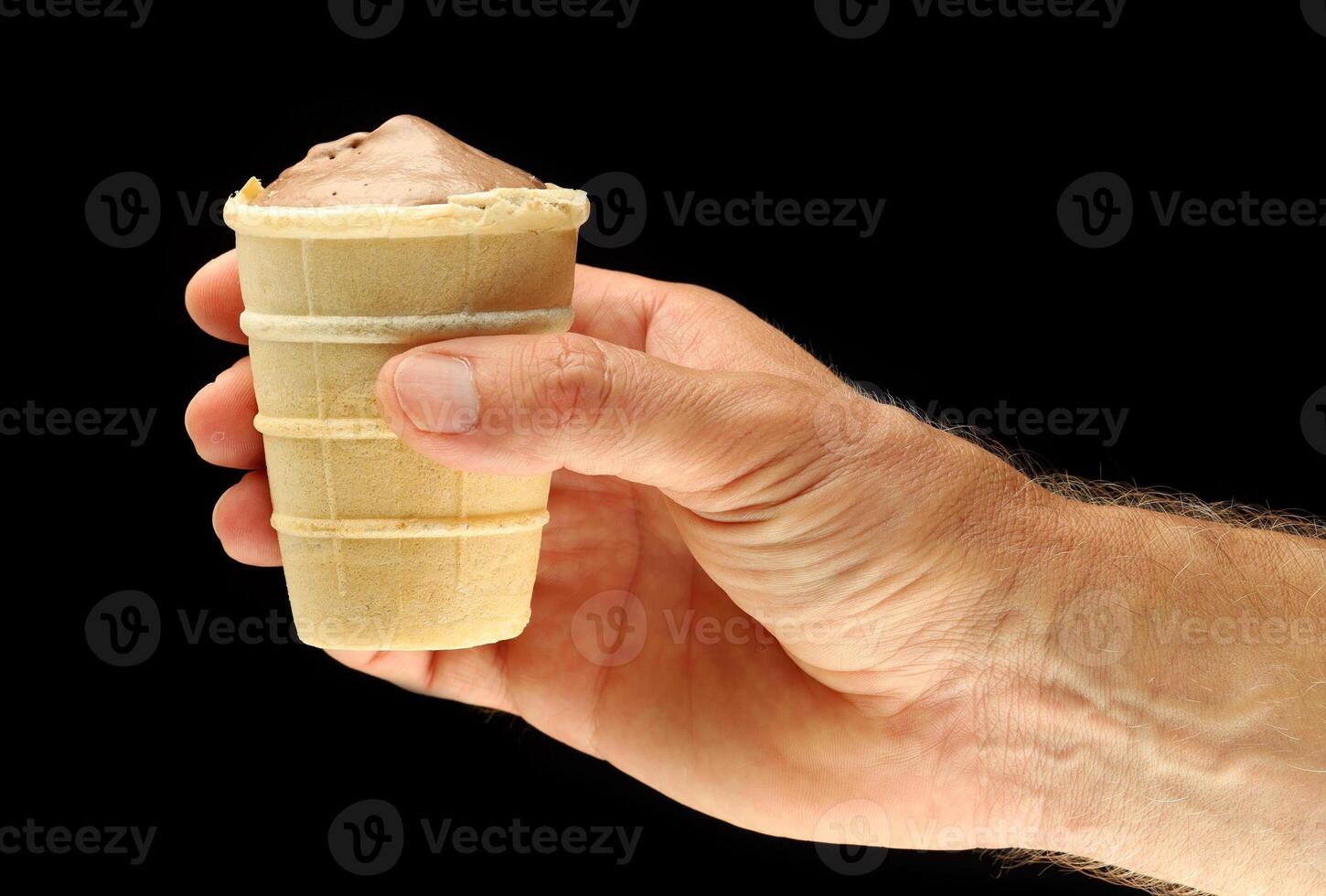 Cocoa ice cream in a waffle cup in hand photo