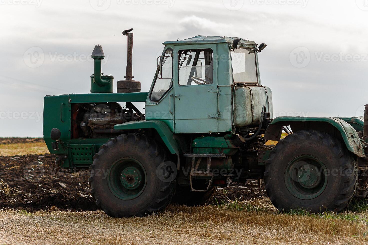 Old tractor plows close-up photo
