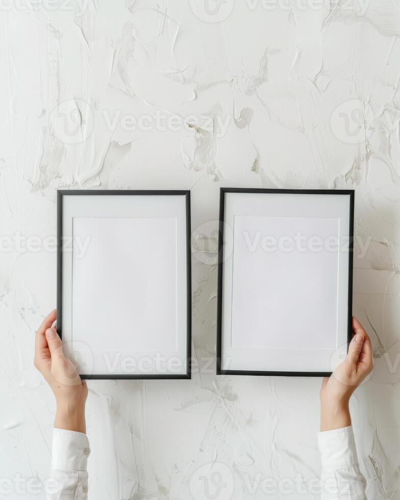 Hands Placing Blank Photo Frames on Wall for Mockup