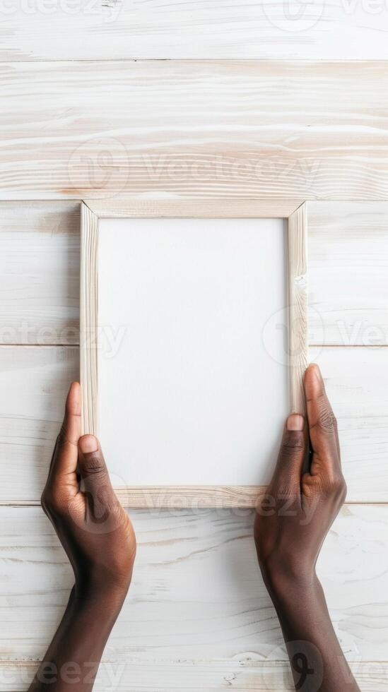 Hands Placing Blank Photo Frames on Wall for Mockup