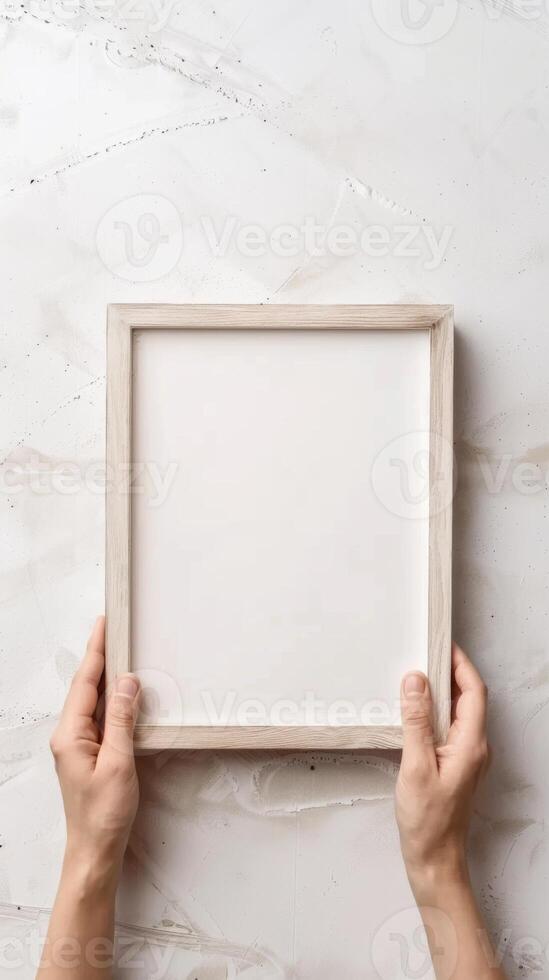 Hands Placing Blank Photo Frames on Wall for Mockup