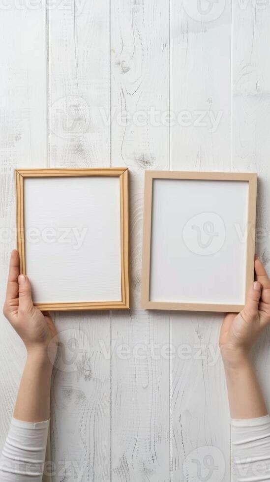 Hands Placing Blank Photo Frames on Wall for Mockup